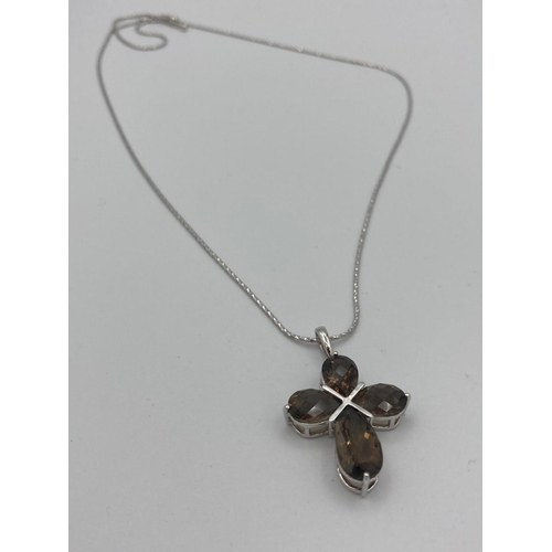 385 - SILVER and SMOKEY QUARTZ  cross pendant having stones set to form a cross,mounted on a quality silve... 