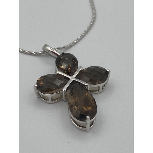 385 - SILVER and SMOKEY QUARTZ  cross pendant having stones set to form a cross,mounted on a quality silve... 