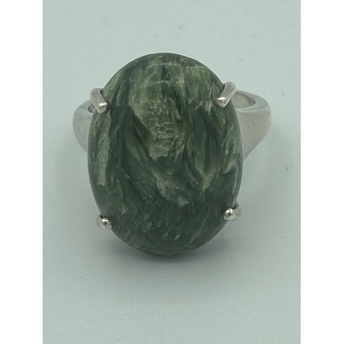 84 - Silver ring having large polished Séraphinite cabochon mounted to top. Séraphinite is thought to hav... 