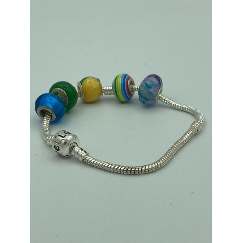 100 - SILVER Pandora style charm bracelet to include SILVER and glass/SILVER and enamel charms.
7 1/2” (19... 