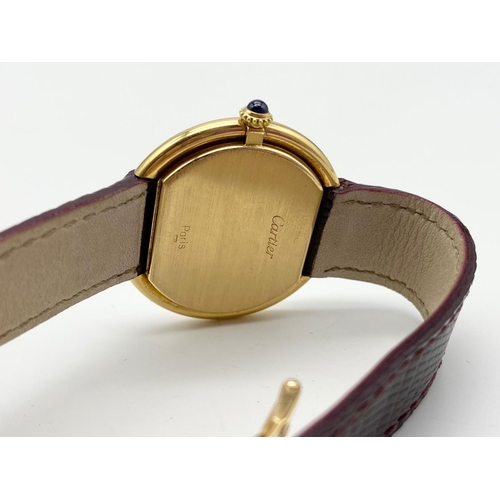 73 - A CARTIER 18K ROSE GOLD CIRCULAR WATCH WITH ROMAN NUMERALS AND LEATHER AND GOLD STRAP.  32mm