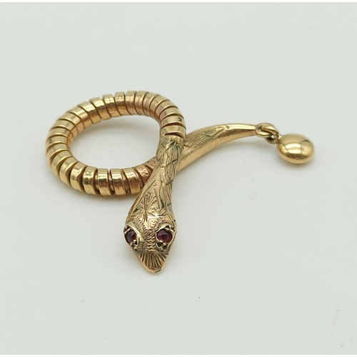 130 - 9k yellow gold snake pendant with ruby eyes, 35mm in length, weighs 4.3 grams