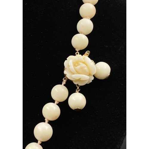 213 - White coral beaded necklace with 14k yellow gold clasp, length 64cm, weighs