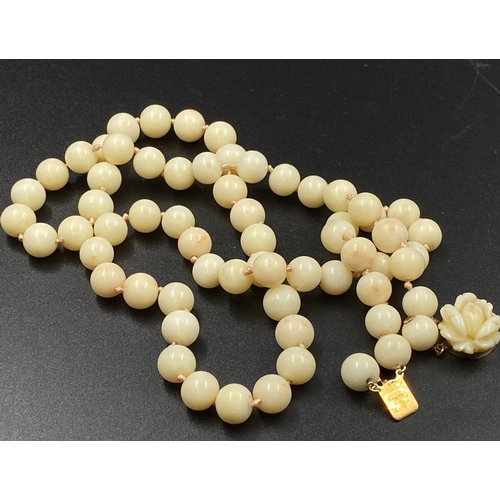 213 - White coral beaded necklace with 14k yellow gold clasp, length 64cm, weighs