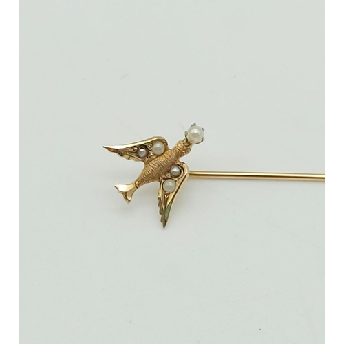 220 - 9k yellow gold tie pin featuring a swallow with seed pearls. weighs 0.7 grams, length 58mm.