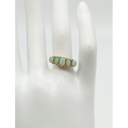 23 - A Beautiful 9K Yellow Gold Five-Stone Opal Ring. Size N.
2.35g