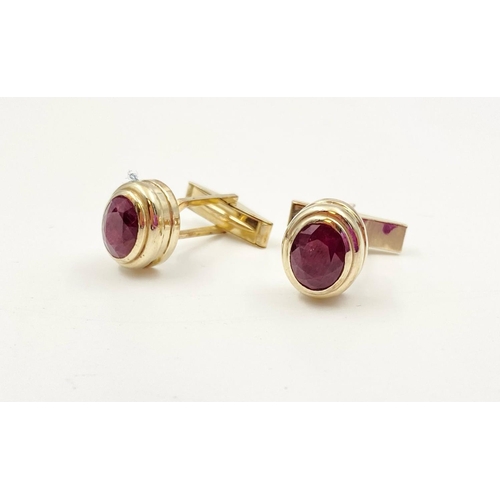 54 - A pair of 14k yellow gold and ruby cufflinks, 4ct in rubies, weighs 10.2 grams