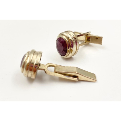 54 - A pair of 14k yellow gold and ruby cufflinks, 4ct in rubies, weighs 10.2 grams