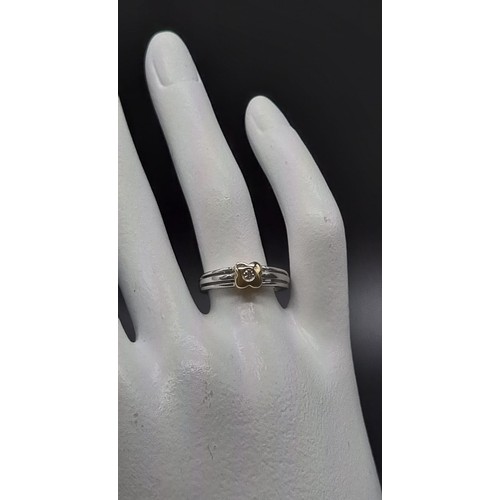 128 - 9k two tone gold solitaire cross over ring with flower and diamond to centre, 0.07ct diamonds, weigh... 