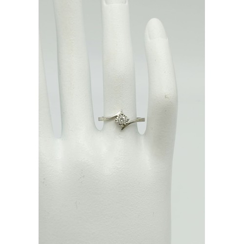 263 - 9k white gold diamond twist solitaire ring, 0.10ct of diamonds, weighs 1.9 grams, ring size N