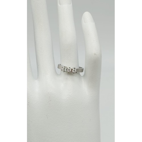 18 - 18k white gold diamond trilogy ring, 0.15ct in diamonds, weighs 3.9 grams, ring size M 1/2/