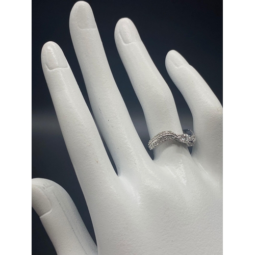 746 - A 9K White Gold Diamond Wave Ring. Centre diamond with diamond waves either sides. 0.75ct Size L. 3g... 