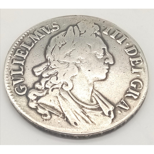 104 - A 1696 William III Silver Crown Coin. Please see photographs for conditions. 29.25g.