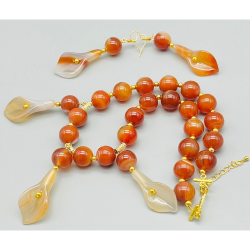 50 - A beautiful, banded, orange agate necklace and earrings set with hand carved lilies. Necklace length... 