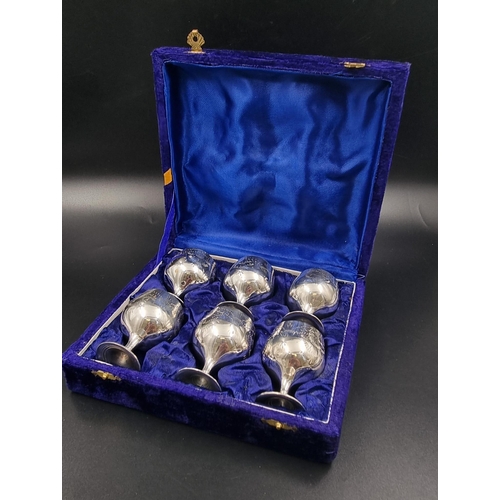 731 - A SET OF 6 SILVER PLATED GOBLETS IN A SATIN LINED VELVET PRESENTATION BOX. EACH GOBLET BEING 6cms IN... 