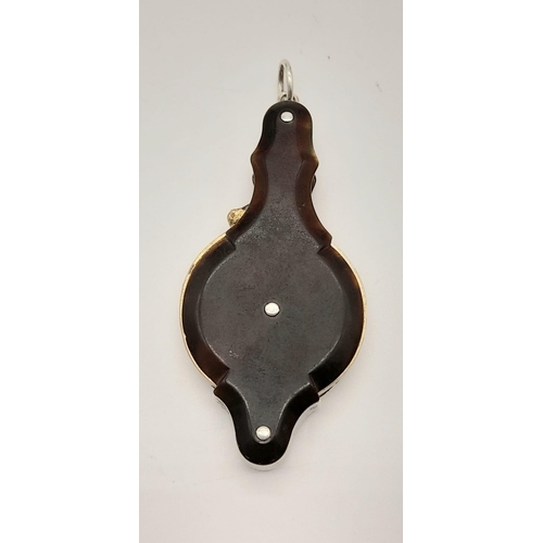 740 - A Victorian magnifying glass with tortoise shell covers. length: 6.8 cm.