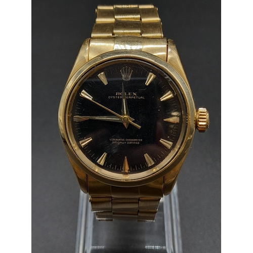 62 - An 18K Gold Rolex Oyster Gents Watch. Gold strap and case - 35mm. Black dial. Automatic movement.
92... 