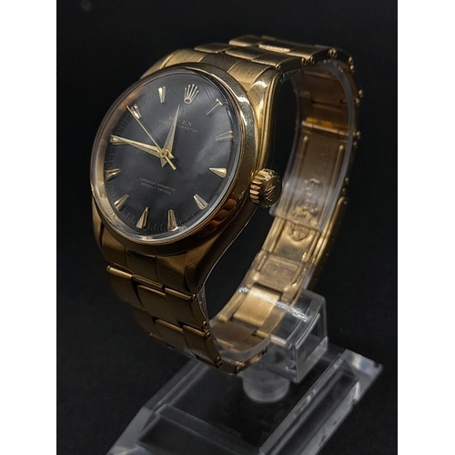 62 - An 18K Gold Rolex Oyster Gents Watch. Gold strap and case - 35mm. Black dial. Automatic movement.
92... 