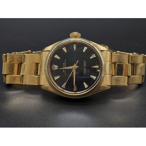 62 - An 18K Gold Rolex Oyster Gents Watch. Gold strap and case - 35mm. Black dial. Automatic movement.
92... 