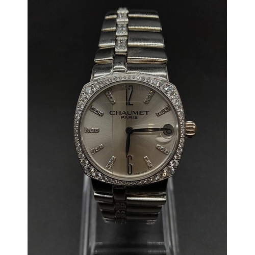 76 - An 18K White Gold Chaumet Ladies Watch. Gold and diamond bracelet and case - 28mm. Silver tone dial.... 