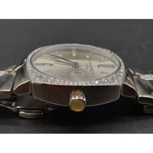 76 - An 18K White Gold Chaumet Ladies Watch. Gold and diamond bracelet and case - 28mm. Silver tone dial.... 