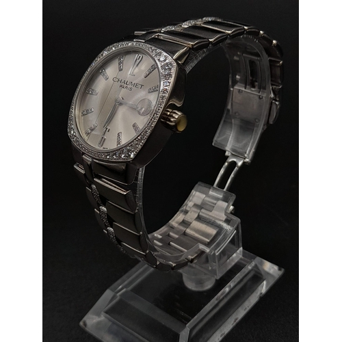 76 - An 18K White Gold Chaumet Ladies Watch. Gold and diamond bracelet and case - 28mm. Silver tone dial.... 