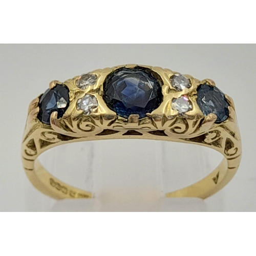 766 - An 18k Yellow Gold Diamond and Sapphire Ring. Three sapphires and four diamonds. Size L. 4.2g