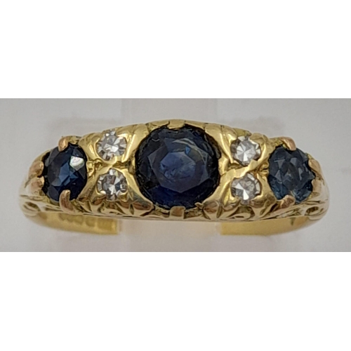 766 - An 18k Yellow Gold Diamond and Sapphire Ring. Three sapphires and four diamonds. Size L. 4.2g