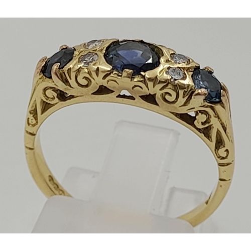 766 - An 18k Yellow Gold Diamond and Sapphire Ring. Three sapphires and four diamonds. Size L. 4.2g