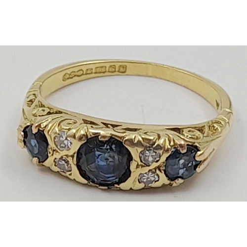 766 - An 18k Yellow Gold Diamond and Sapphire Ring. Three sapphires and four diamonds. Size L. 4.2g