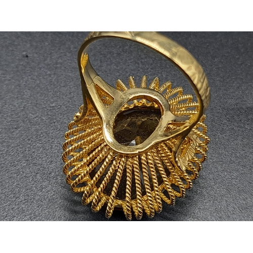 31 - An 18 K yellow gold ring with a massive, oval cut, smoky quartz. Ring size: R, weight: 12.73 g.