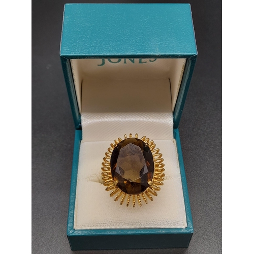 31 - An 18 K yellow gold ring with a massive, oval cut, smoky quartz. Ring size: R, weight: 12.73 g.