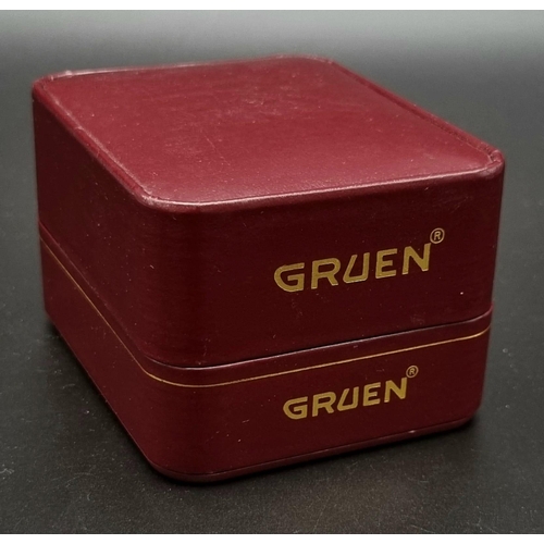 734 - A VINTAGE GRUEN QUARTX WATCH IN ORIGINAL BOX WITH OWNERS MANUAL.