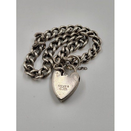 742 - An Early Solid Silver Bracelet with Heart Clasp. 18cm.
15.5g