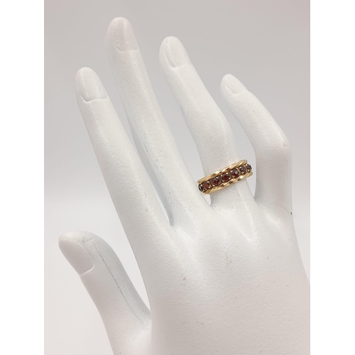 52 - A vintage, 9 K yellow gold, full eternity ring with garnets. Ring size: M, weight: 5.27 g. In a pres... 