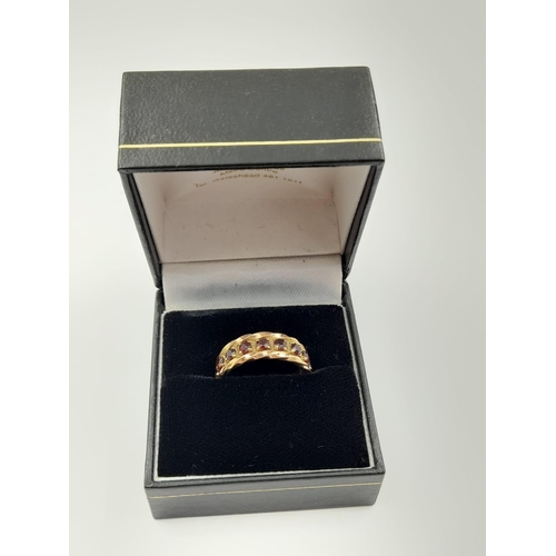 52 - A vintage, 9 K yellow gold, full eternity ring with garnets. Ring size: M, weight: 5.27 g. In a pres... 