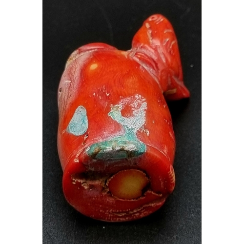 101 - An antique, Chinese, red coral, snuff bottle, with carved bird on side. Top missing. Dimensions: 6.5... 