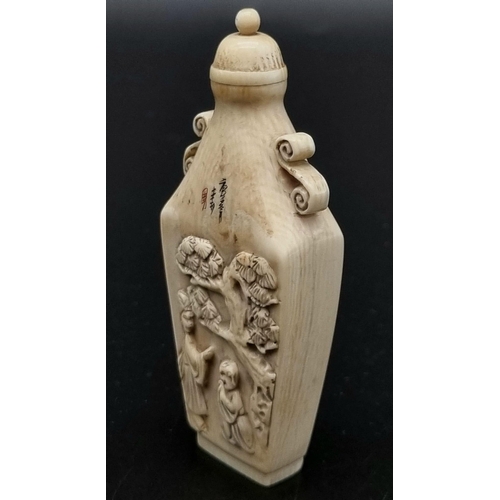 29 - A 19th Century, carved ivory snuff bottle from the Orient. Unusual shape, good engraving and calligr... 