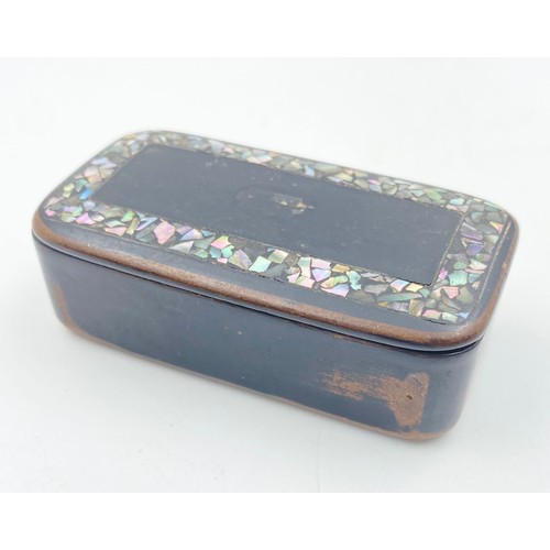 726 - An Antique Papier Mache Snuff Box with Mother of Pearl Inlay. 2 x7cm.