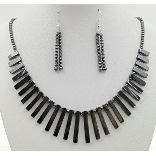 231 - A beautiful, modern necklace, bracelet and earrings set made of highly polished haematite. In a pres... 