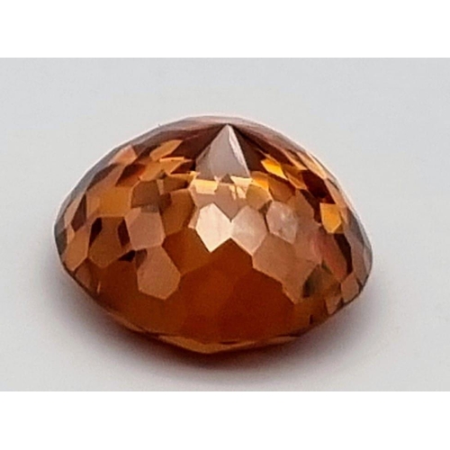 245 - A large (127 carats), flawless, round cut, natural zircon. Beautiful champagne colour with good satu... 