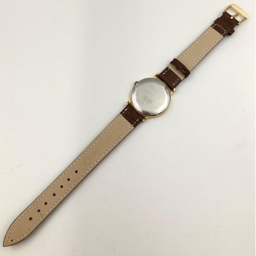 230 - A Raymond Weil Quartz Gents Watch. Leather strap. Two-tone case - 32mm. White dial. In working order... 