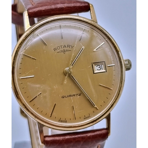 134 - A Rotary Quartz Gents 9k Gold Watch. Leather strap. 9K gold case - 33mm. Gold dial with date window.... 