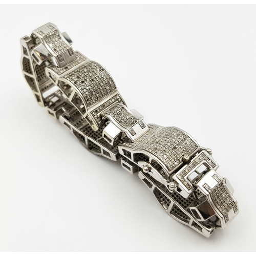 20 - A 10 K white gold bracelet with sapphires (some missing). Length: 18 cm, weight: 34.7 g.