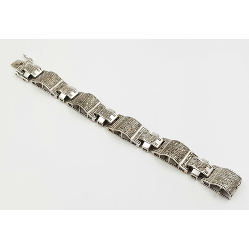 20 - A 10 K white gold bracelet with sapphires (some missing). Length: 18 cm, weight: 34.7 g.