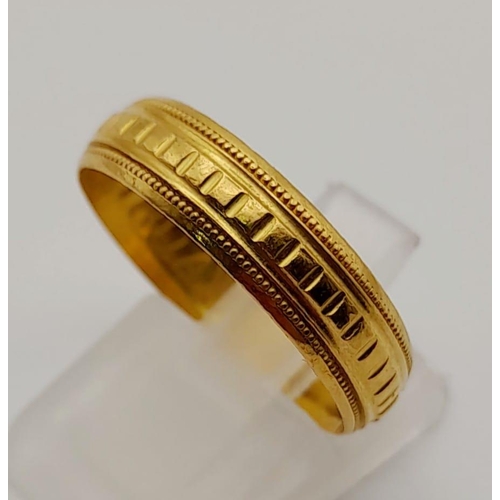 69 - Three 22K Yellow Gold Rings: A large rectangular signet ring with nine gemstones - size S. A band ri... 