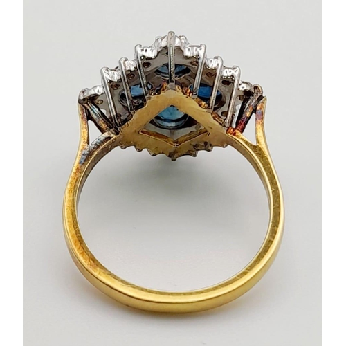 453 - An 18K Yellow Gold Diamond and Sapphire Ring. Four clean blue sapphires surrounded by a cluster of d... 