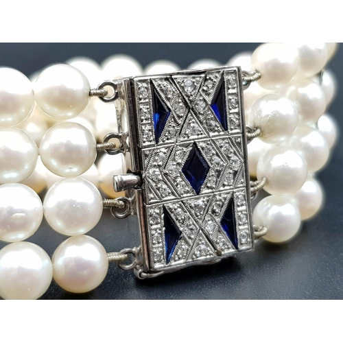 482 - A 4 ROW AKOYA PEARL BRACELET WITH ART DECO STYLE 14K GOLD DIAMOND AND SAPPHIRE CLASP. 67.3gms