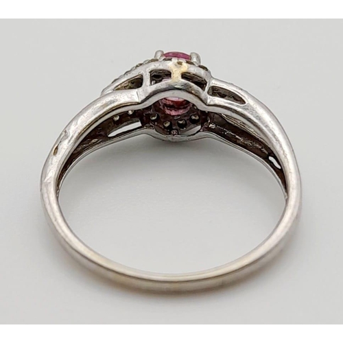 525 - A 9K White Gold Pink Sapphire and Diamond Cluster Ring. 0.10ct. Size K 1/2. 1.7g