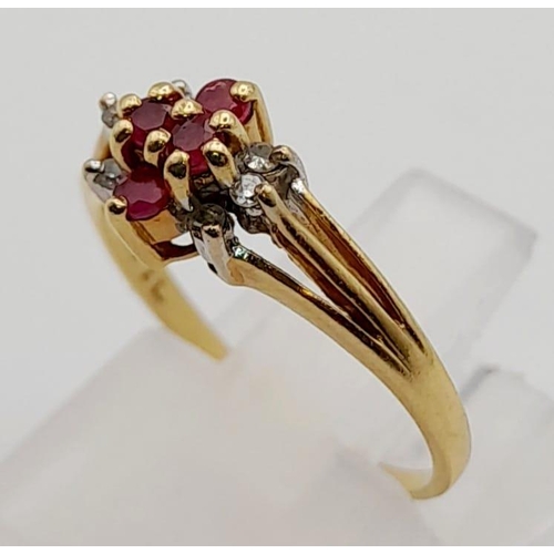 552 - A 14K Yellow Gold Diamond and Ruby Cluster Ring. Size J. 1.7g